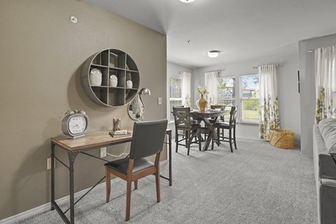A dining room with a table and chairs.