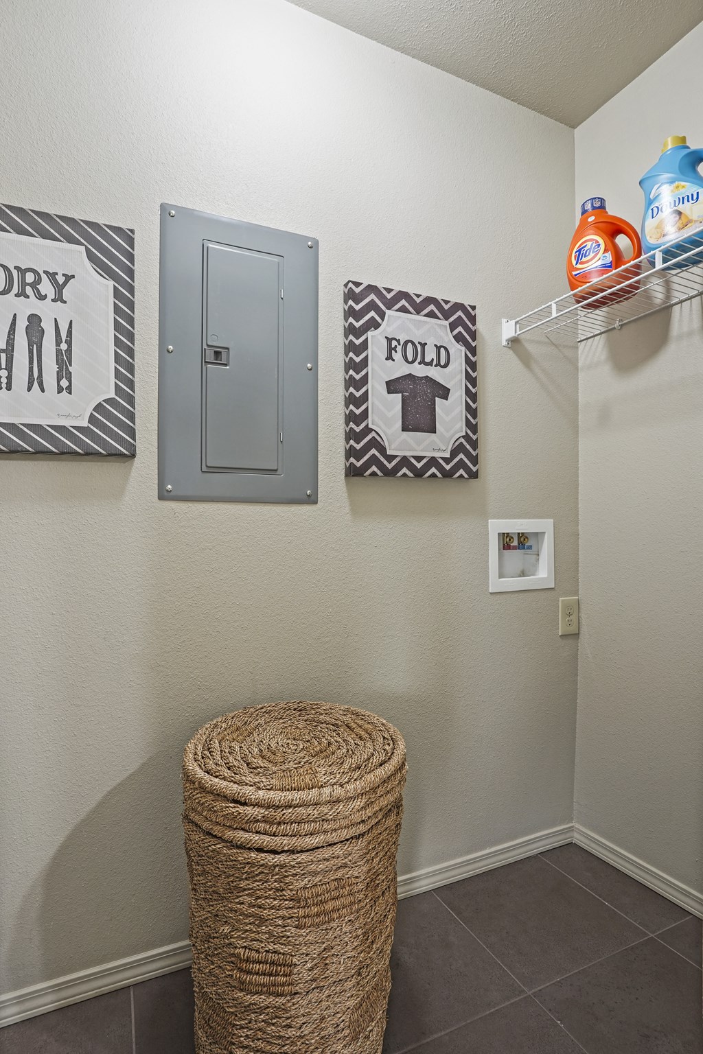 A laundry room with a dryer and a fold sign.