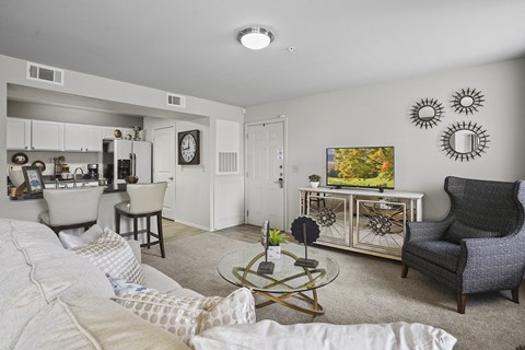A living room with a white couch and a coffee table.