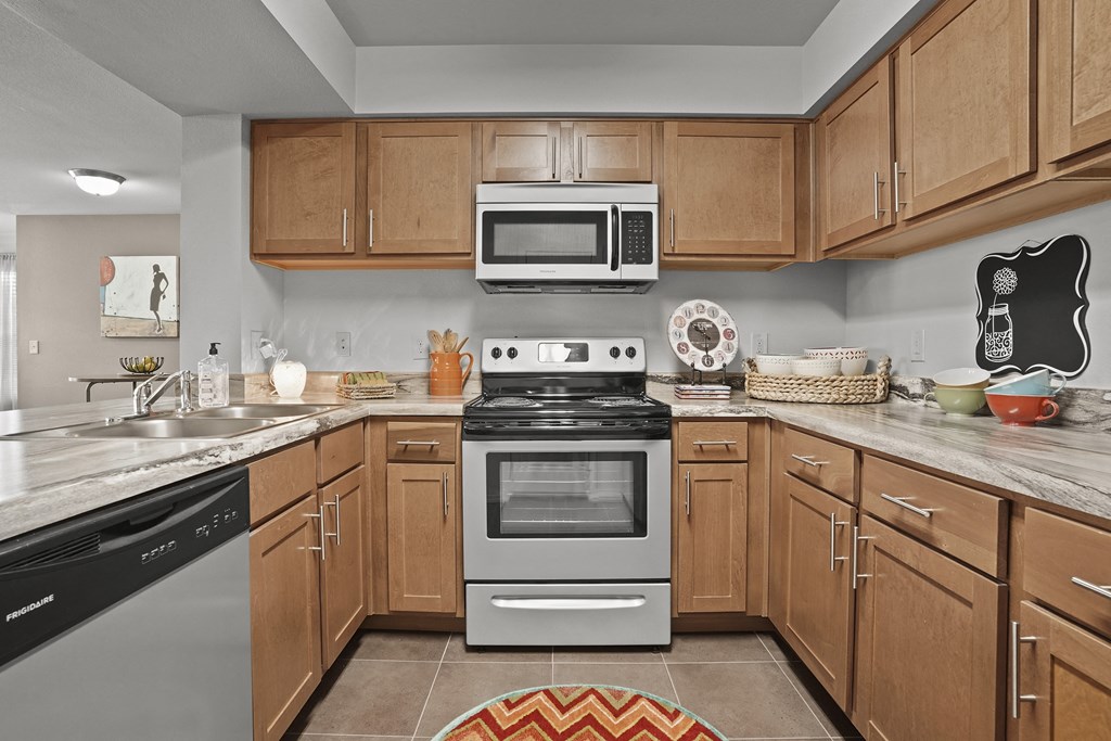 A kitchen with a stove top oven and microwave above it.