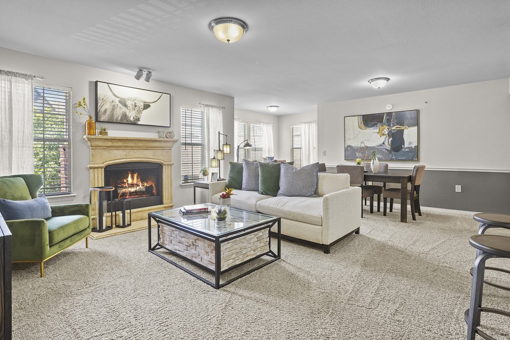 A living room with a fireplace and a painting on the wall.