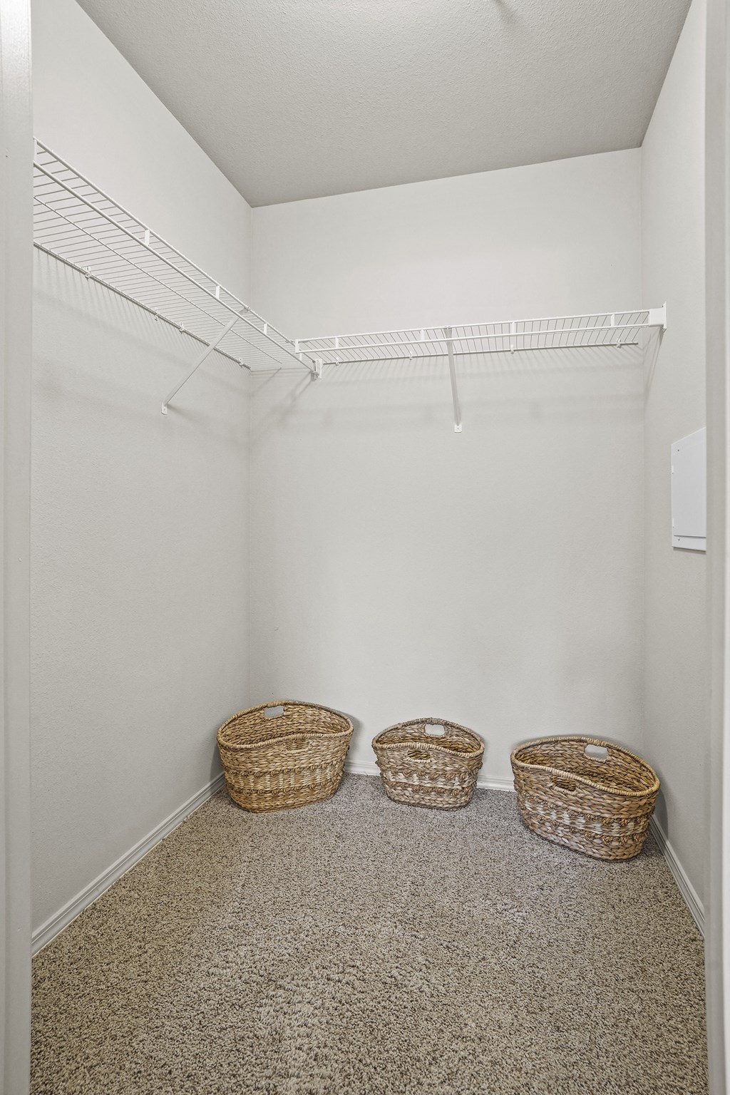 A storage room with two baskets on the floor.