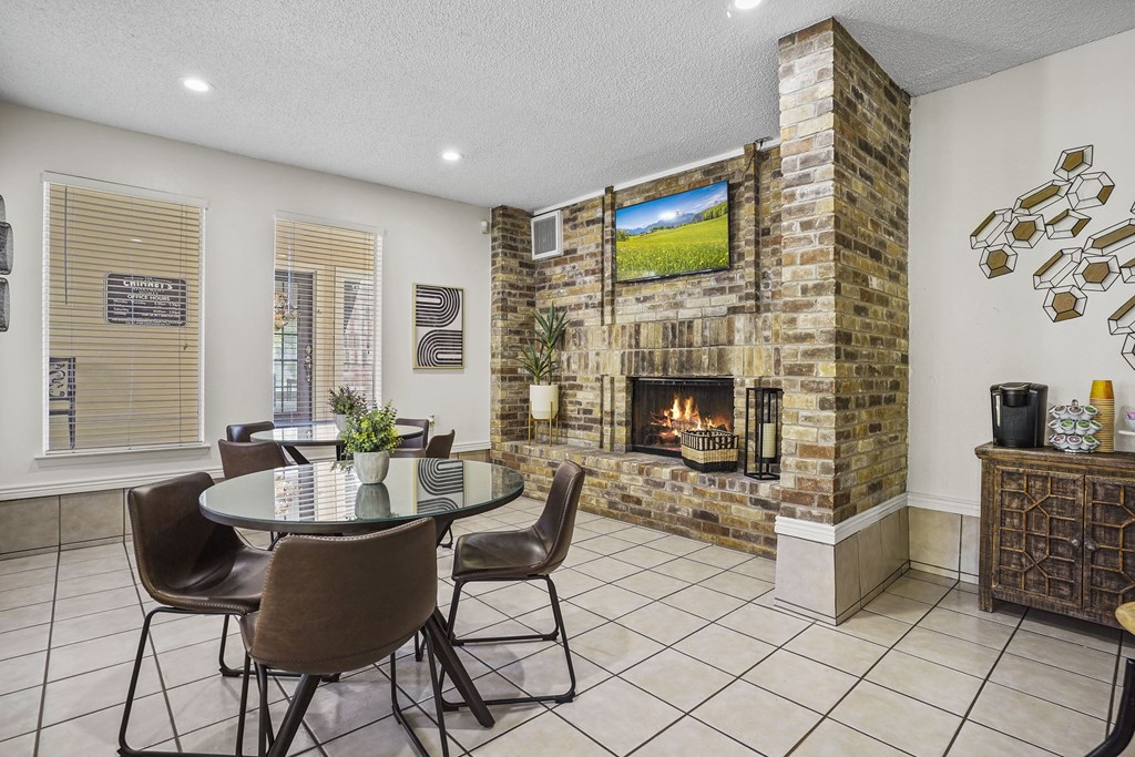 A living room with a fireplace and a TV mounted on the wall.