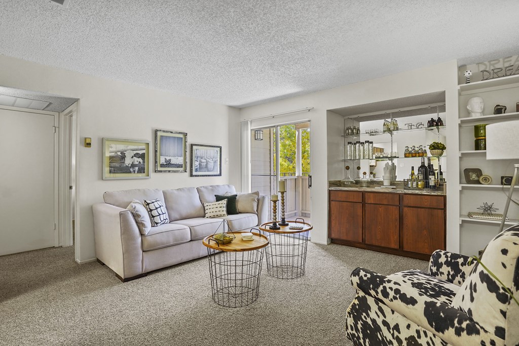 A living room with a couch, a chair, and a coffee table.