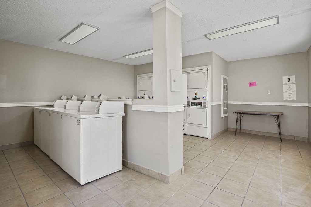 A kitchen with white appliances and a white counter.