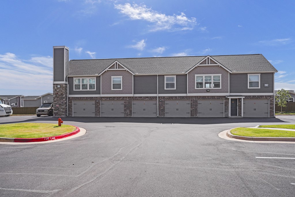A grey building with a red fire hydrant in front.