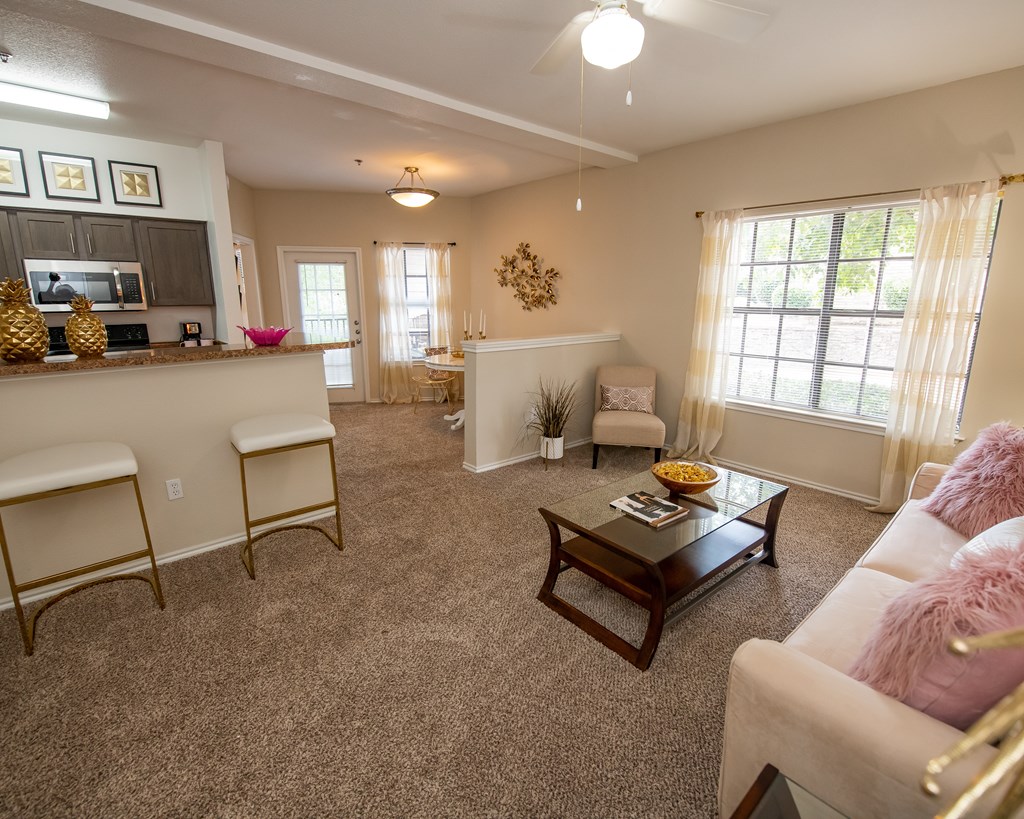 A living room with a couch, chairs, and a coffee table.