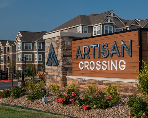 an artistic crossing sign in front of an apartment building