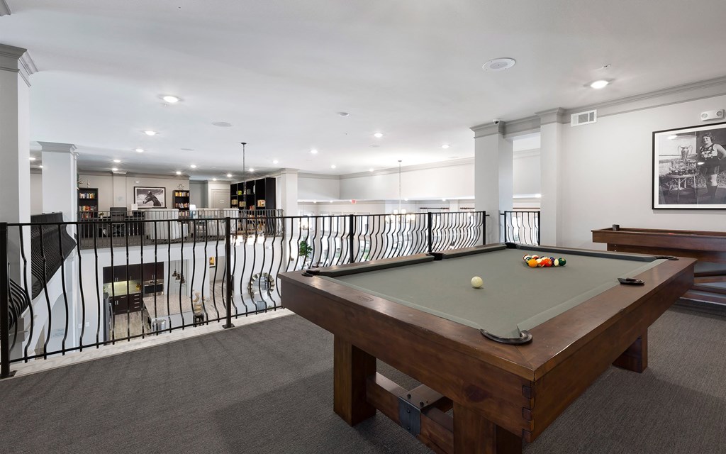 a games room with a pool table and a bar