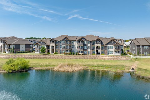 A row of houses with a body of water in front.