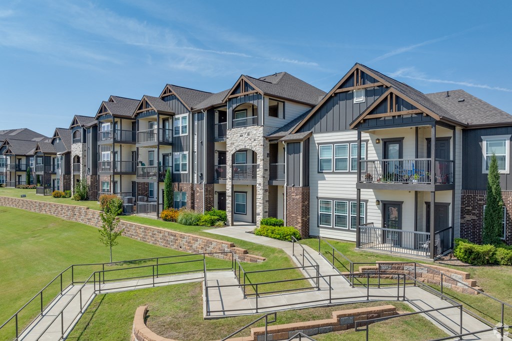 A row of modern houses with a playground in the foreground.