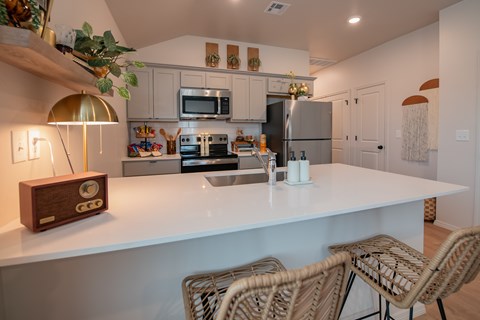 A kitchen with a white countertop and a clock on it.
