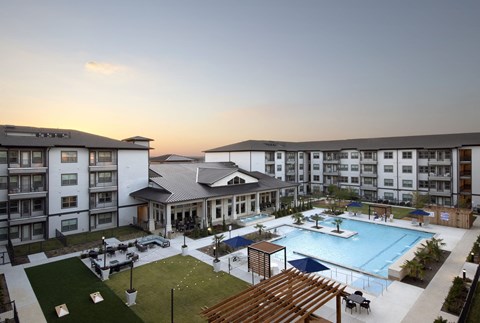 an aerial view of an apartment complex with a swimming pool