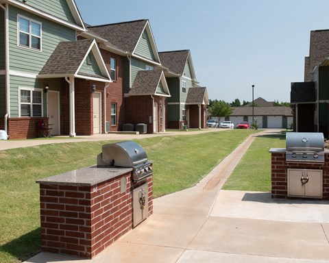 A row of houses with brick and green siding.