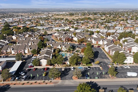 A suburban neighborhood with houses and parked cars.