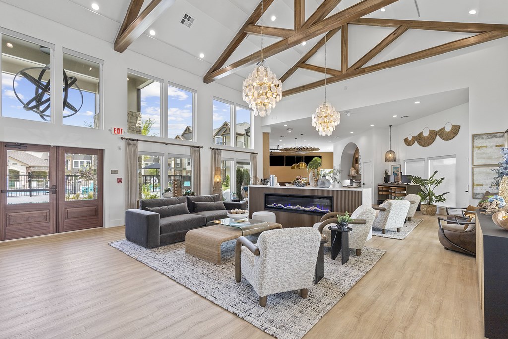 A spacious living room with a fireplace and a large rug.