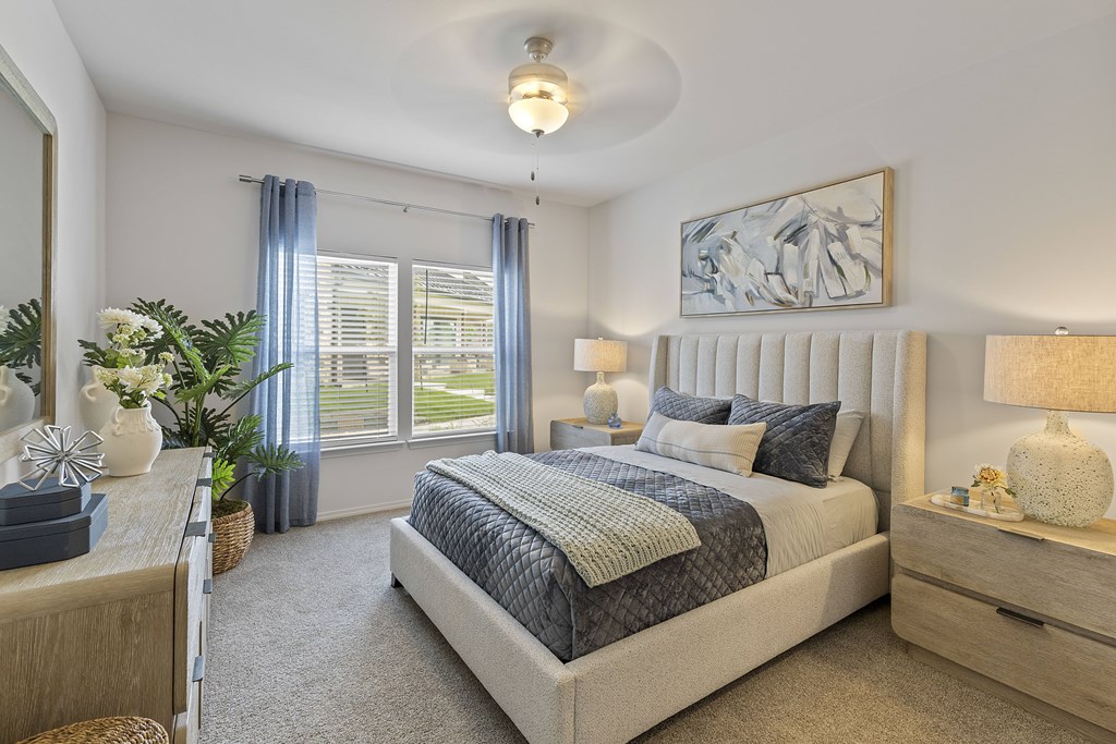 A bedroom with a large bed and a painting on the wall.