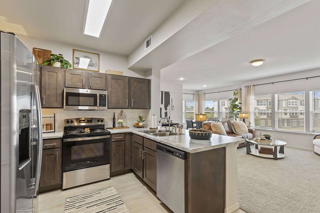 A modern kitchen with stainless steel appliances and a large island.