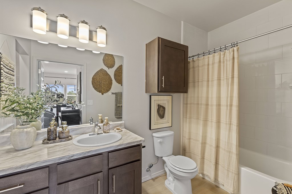 A bathroom with a white toilet and a sink.