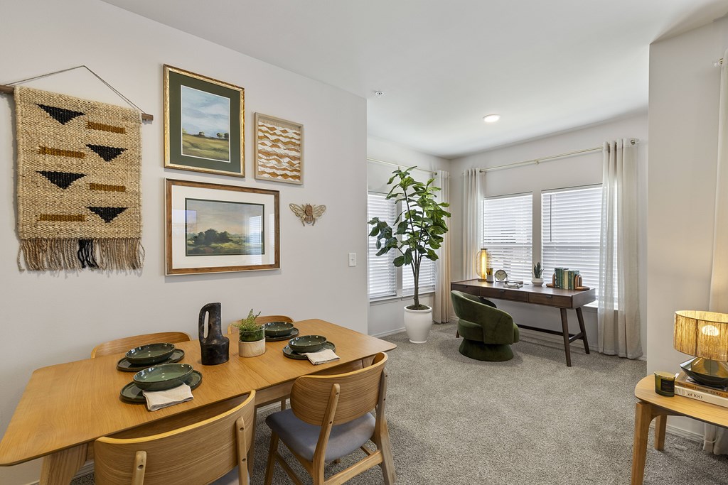 A dining room with a wooden table set for four.