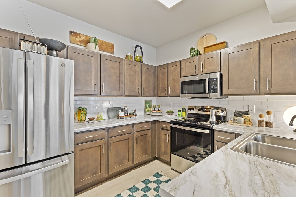 A kitchen with wooden cabinets and a white refrigerator.