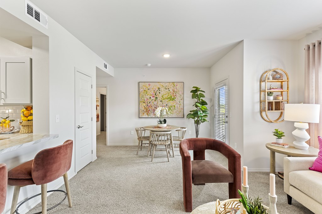 A living room with a dining table and chairs.