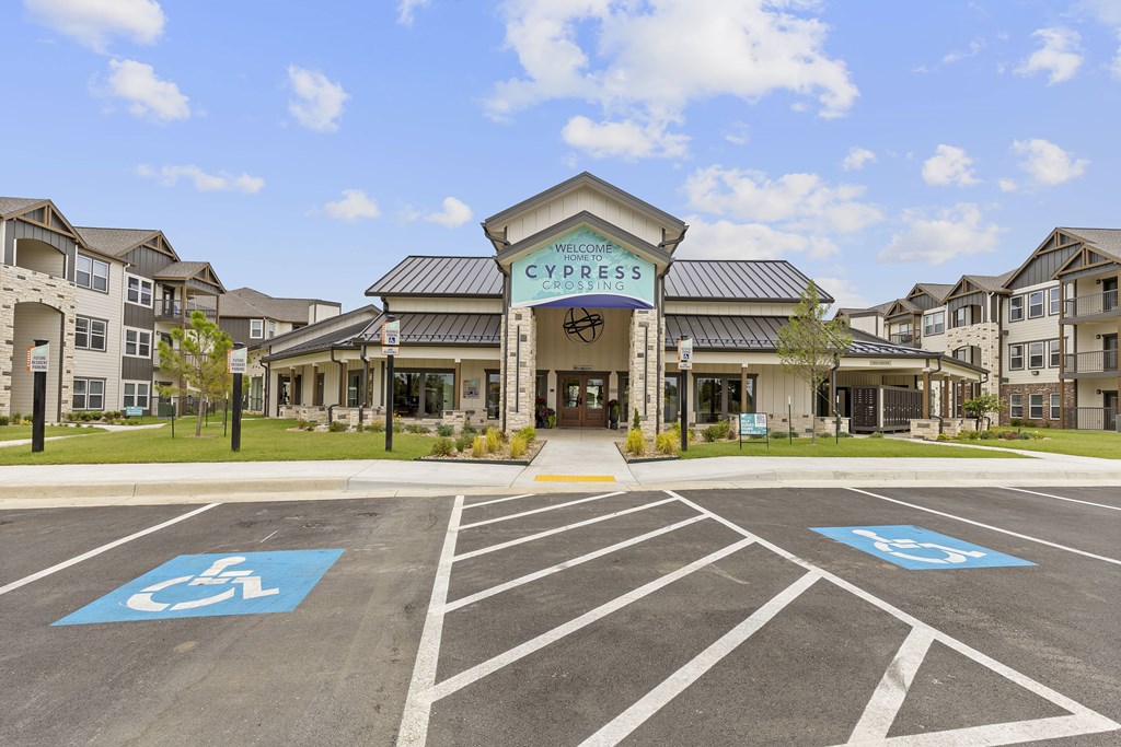 A parking lot with a building entrance and a sign that says "Welcome to Cypress".