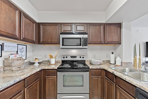 A kitchen with a stove top oven and microwave above it.