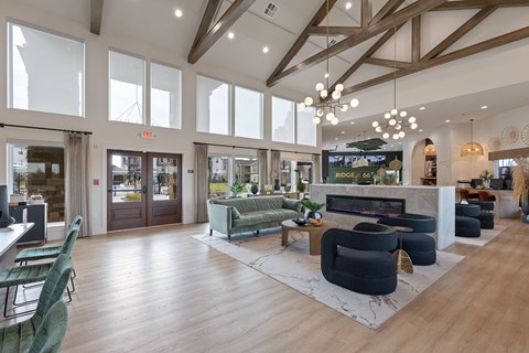A spacious living room with a green sofa and a fireplace.