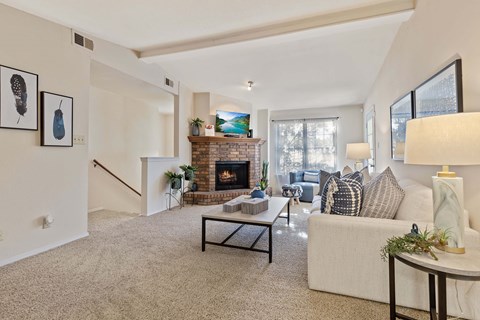 A living room with a fireplace and a couch.