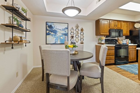 A dining room with a table and chairs.