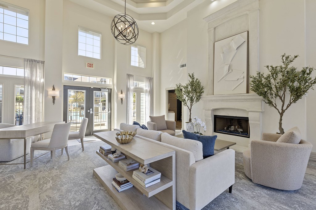 A living room with a fireplace and a painting on the wall.