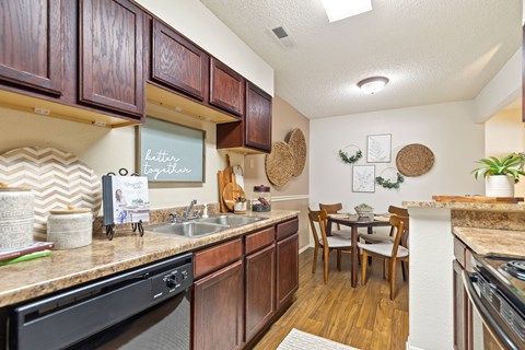 A kitchen with wooden cabinets and a sink.