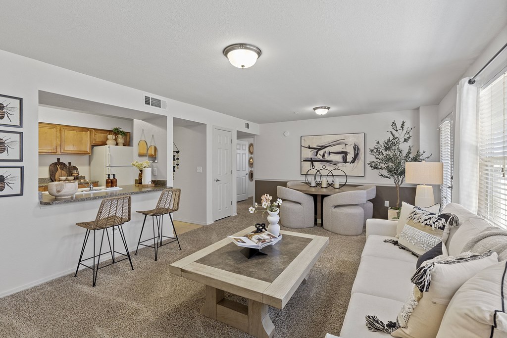 A living room with a white couch and a coffee table.
