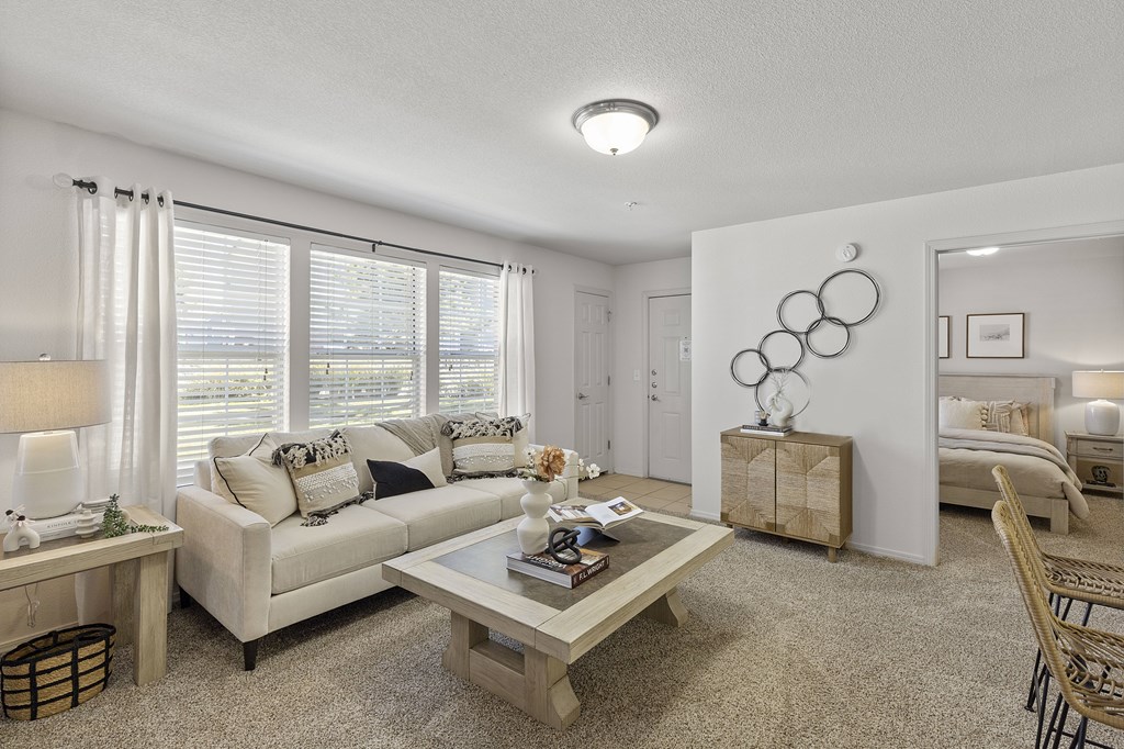 A living room with a couch, a coffee table, and a lamp.