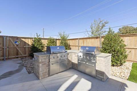 A BBQ grill set on a patio.