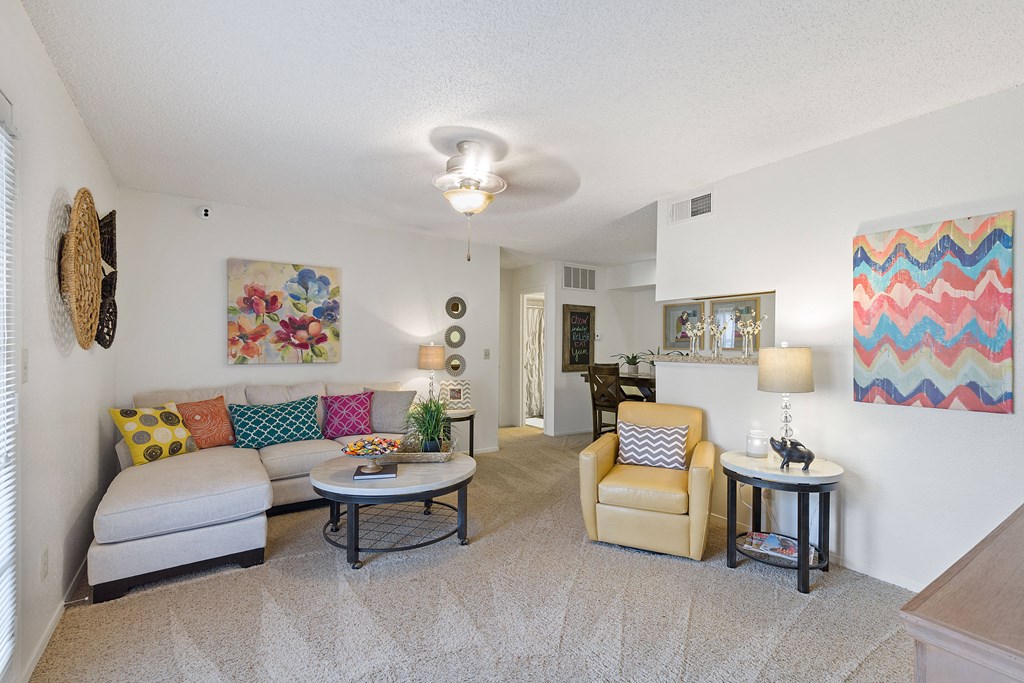 A living room with a couch, chair, and table.