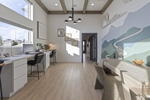 A modern office with a large desk and a painting on the wall.