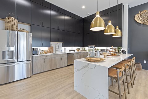 A modern kitchen with a marble island and stainless steel appliances.