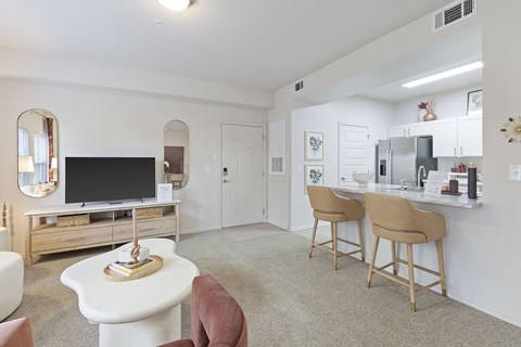 A living room with a white couch and a television.