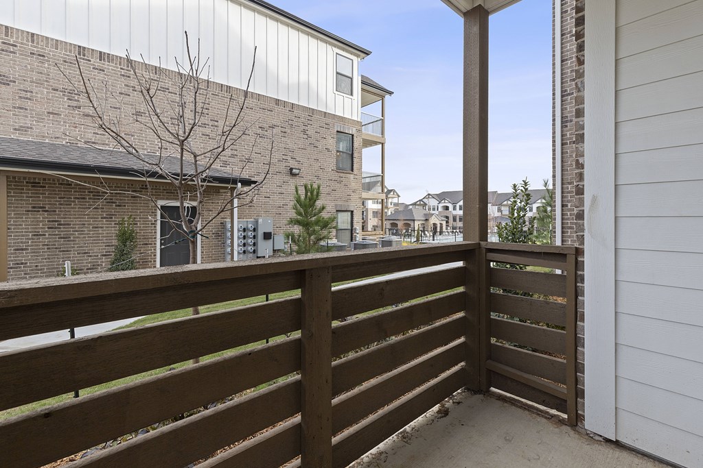 A brown wooden fence in front of a building.