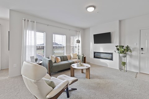 A living room with a couch, chair, and television.