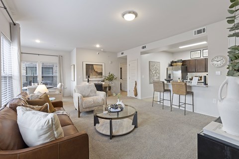A living room with a brown leather couch and a coffee table.