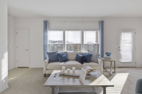 A living room with a white couch and a coffee table.