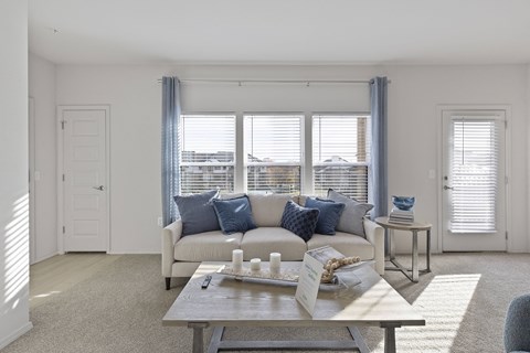 A living room with a white couch and a coffee table.