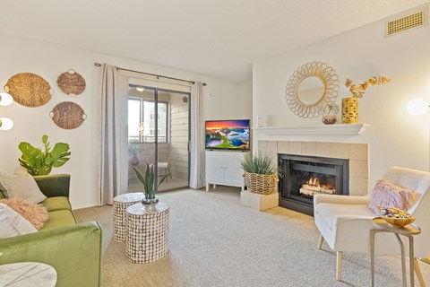A living room with a fireplace and a flat screen TV.
