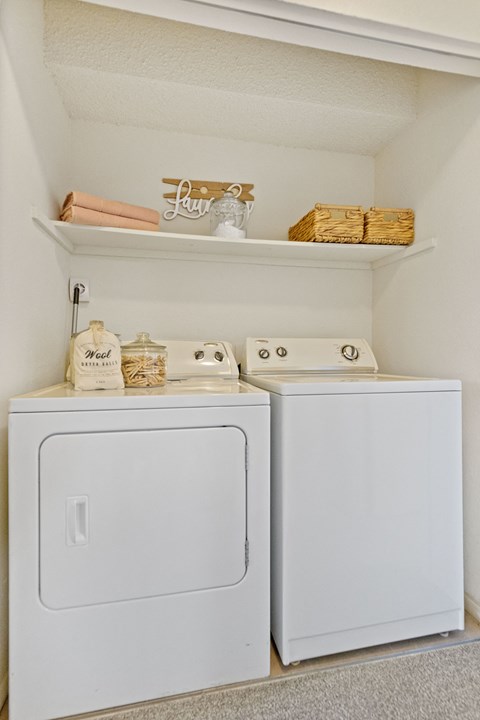 A small laundry room with a washer and dryer.
