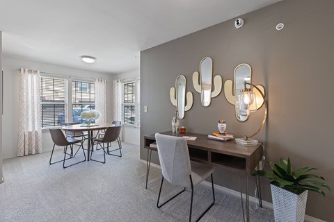 A dining room with a table and chairs.