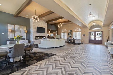 A spacious living room with a fireplace and a large rug.