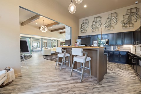 A kitchen with a bar area and a dining table.